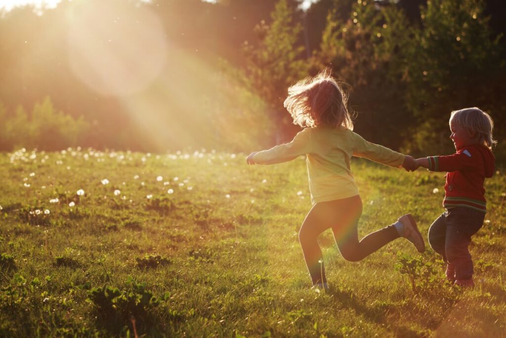 Children running in open fields — acreage lifestyle at Mill Rise Estate, Clarence Town NSW